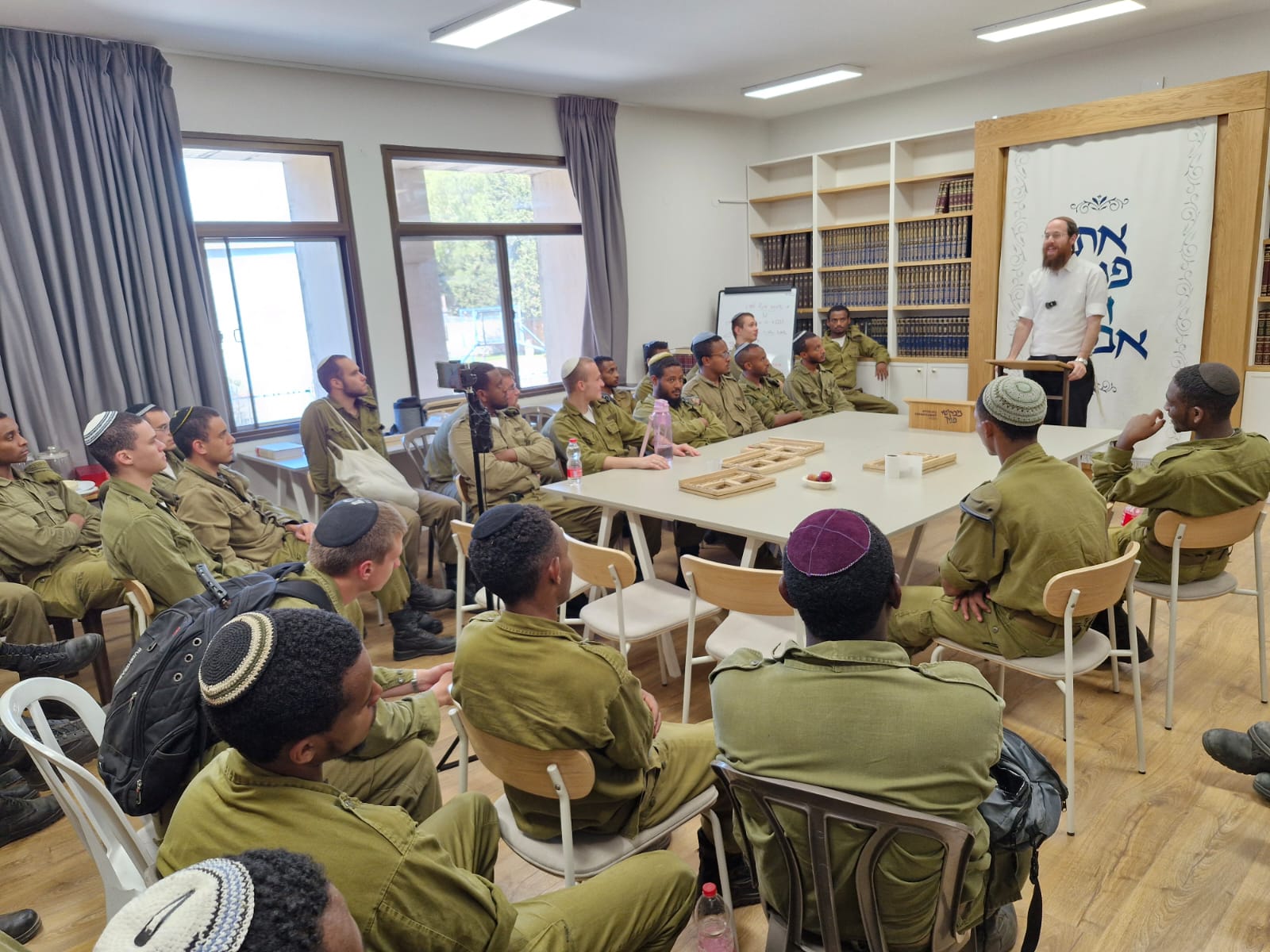 Israeli soldiers listening and connecting at Mevakshei Panecha